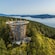 A tall and circular structure standing over the trees of a forest in Victoria, British Columbia